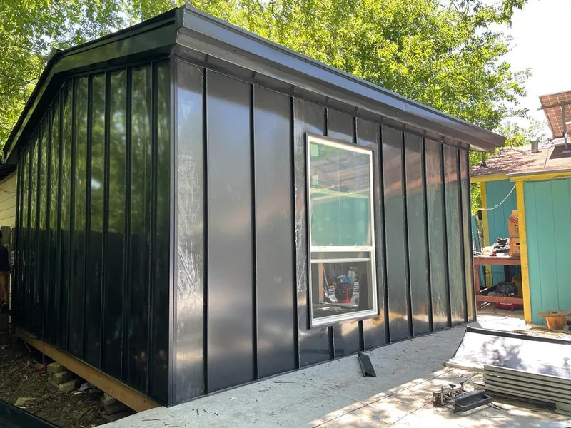 Black standing seam metal wall panels for Roof Inspection in Edmond