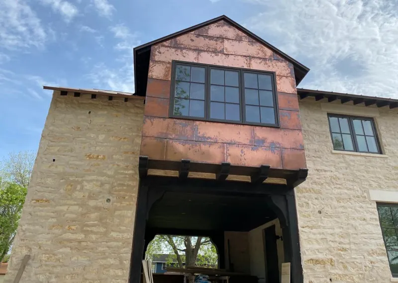 Copper metal panel facade on a stone building for Skylight Installation in Edmond