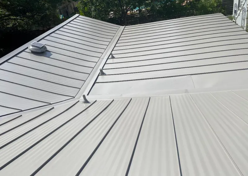 Solar attic fan installed on a metal roof for Roof Ventilation in Edmond